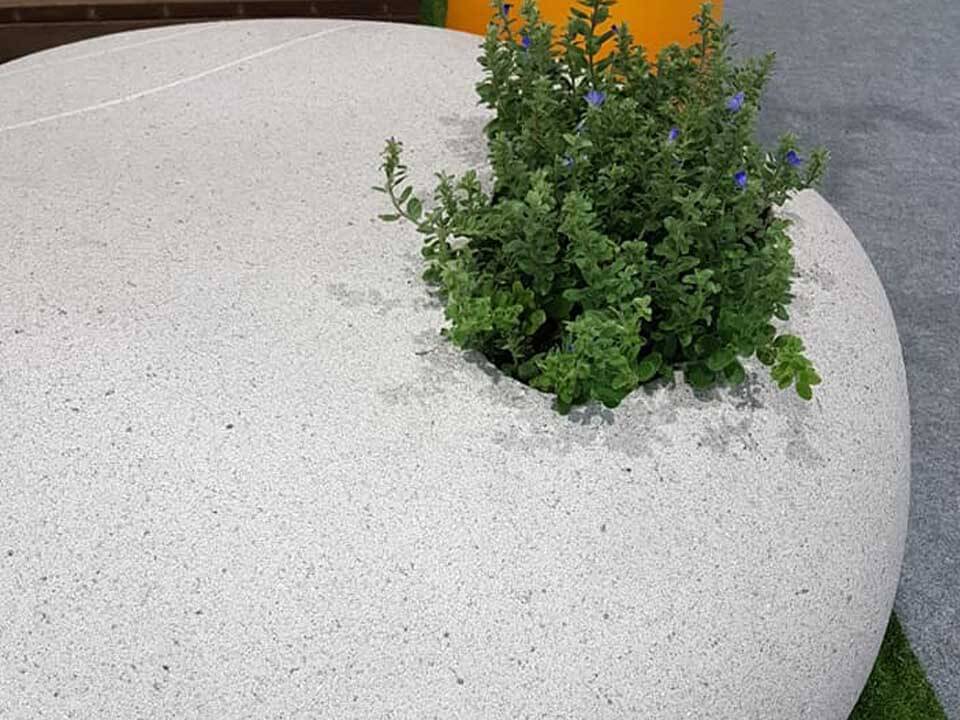 The fake cobblestone made of Styrofoam with ADD STONE imitation stone paint covered looks like real granite. Digging a hole, put some soil and grow plant in it, this can be a beautiful interior decoration without sand problem.
