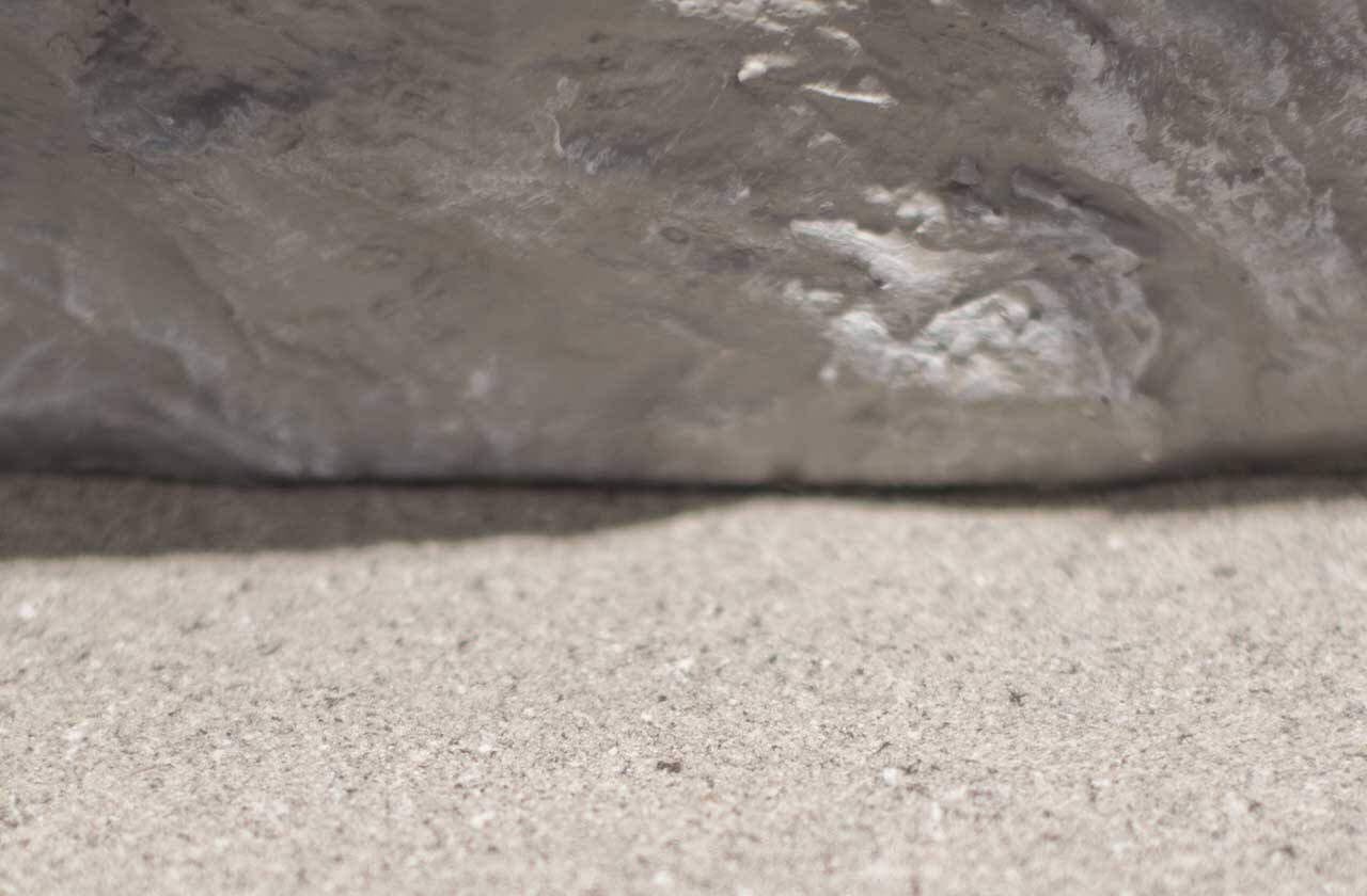 Real granite and the surface of ADD STONE faux-stone coating