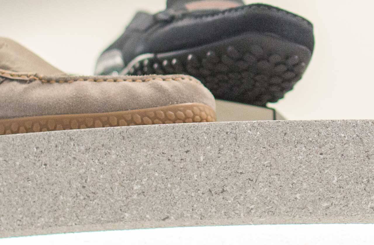 The surface of the cylinder shoes display shelf is sprayed with ADD STONE Granite Texture Faux-Stone Coating.